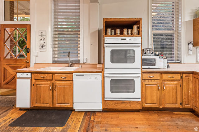 21 North Main Street Kingston, UT 84743 - Photo 71 of 107 Kitchen with white appliances, light countertops, light wood finished floors, and wood finish cabinets