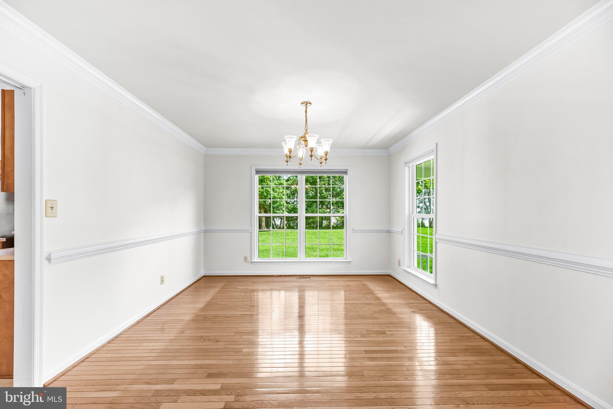 5965 Ketch Road Prince Frederick, MD 20678 - Photo 11 of 56 a view of an empty room with wooden floor and a window