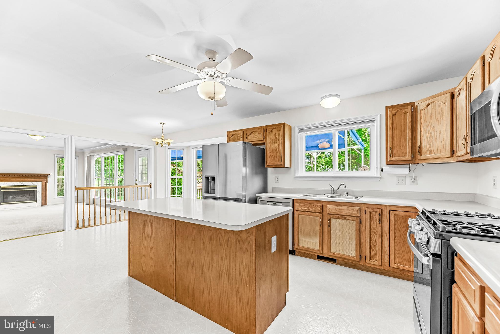 5965 Ketch Road Prince Frederick, MD 20678 - Photo 13 of 56 a large kitchen with stainless steel appliances granite countertop a lot of counter space and wooden floors