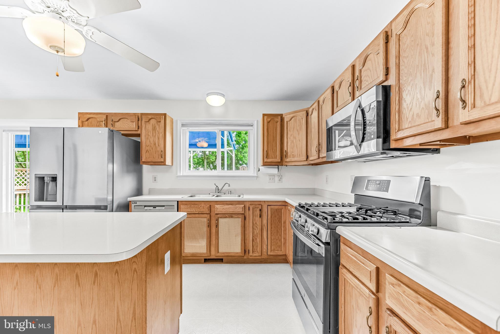 5965 Ketch Road Prince Frederick, MD 20678 - Photo 14 of 56 a kitchen with stainless steel appliances granite countertop a sink stove and refrigerator