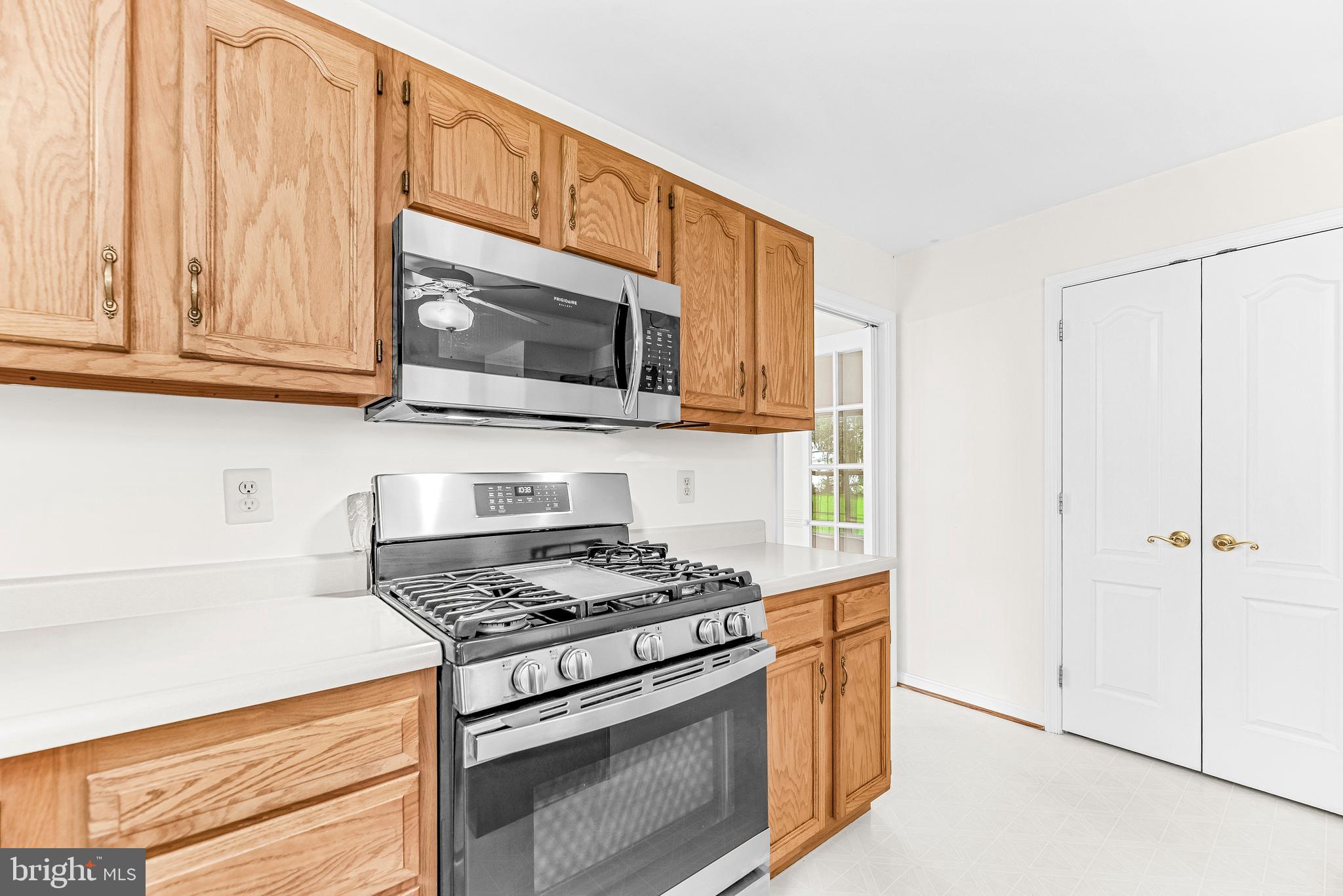 5965 Ketch Road Prince Frederick, MD 20678 - Photo 16 of 56 a kitchen with stainless steel appliances granite countertop a stove a microwave and a refrigerator