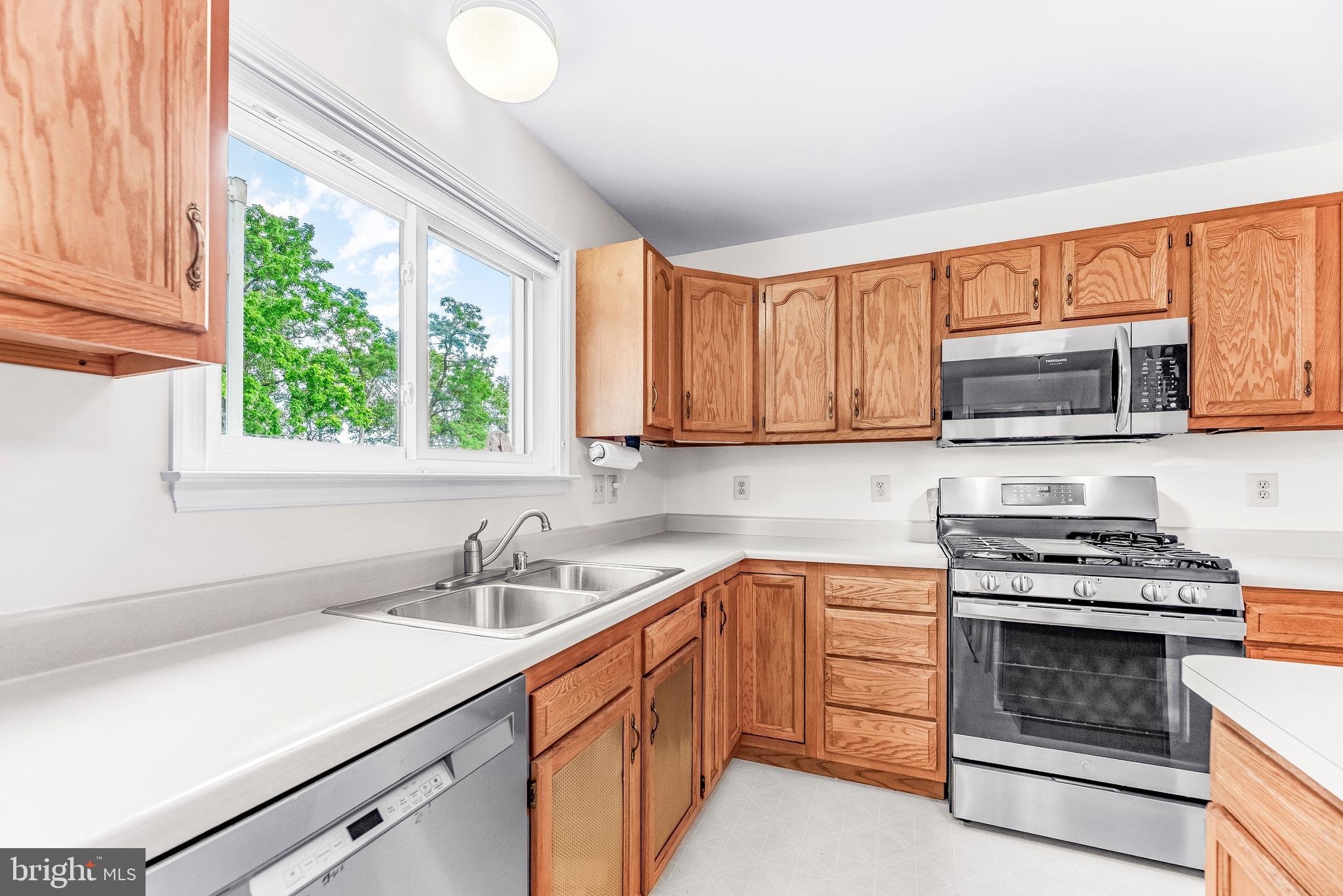 5965 Ketch Road Prince Frederick, MD 20678 - Photo 17 of 56 a kitchen with a sink stove and microwave
