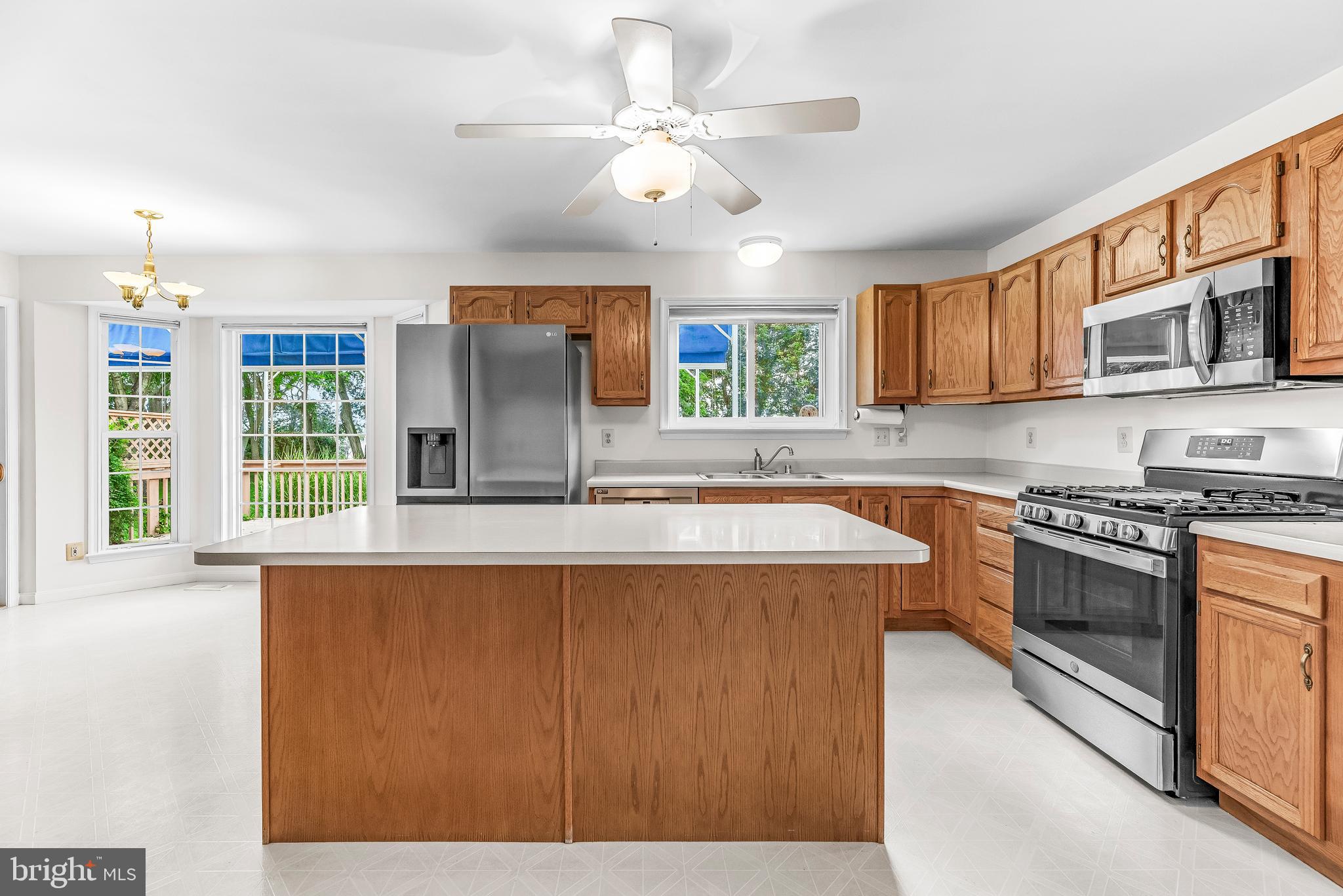 5965 Ketch Road Prince Frederick, MD 20678 - Photo 19 of 56 a kitchen with stainless steel appliances granite countertop a sink stove and refrigerator