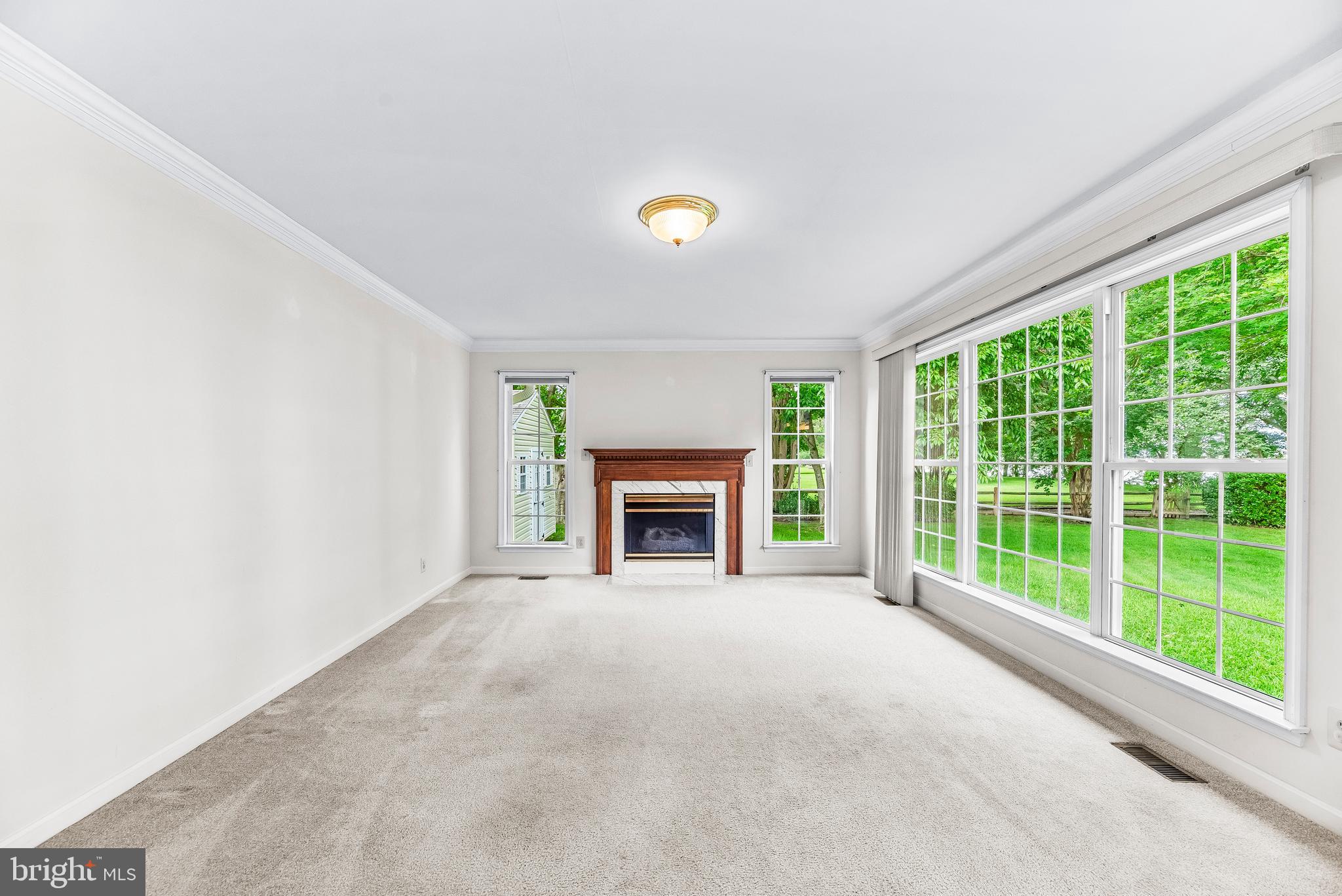 5965 Ketch Road Prince Frederick, MD 20678 - Photo 21 of 56 a view of an empty room with a fireplace and a window