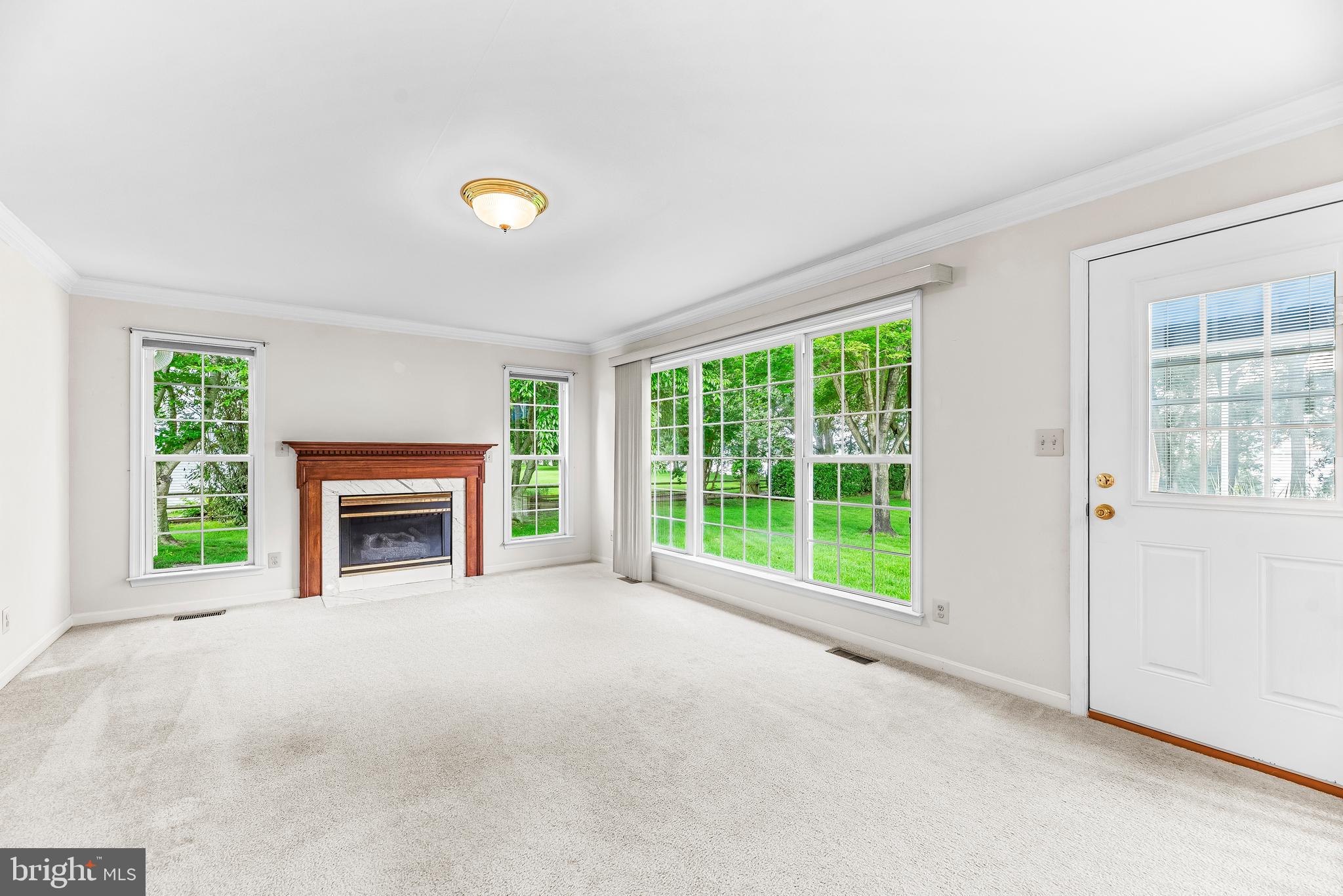 5965 Ketch Road Prince Frederick, MD 20678 - Photo 22 of 56 a view of an empty room with a window and a fireplace