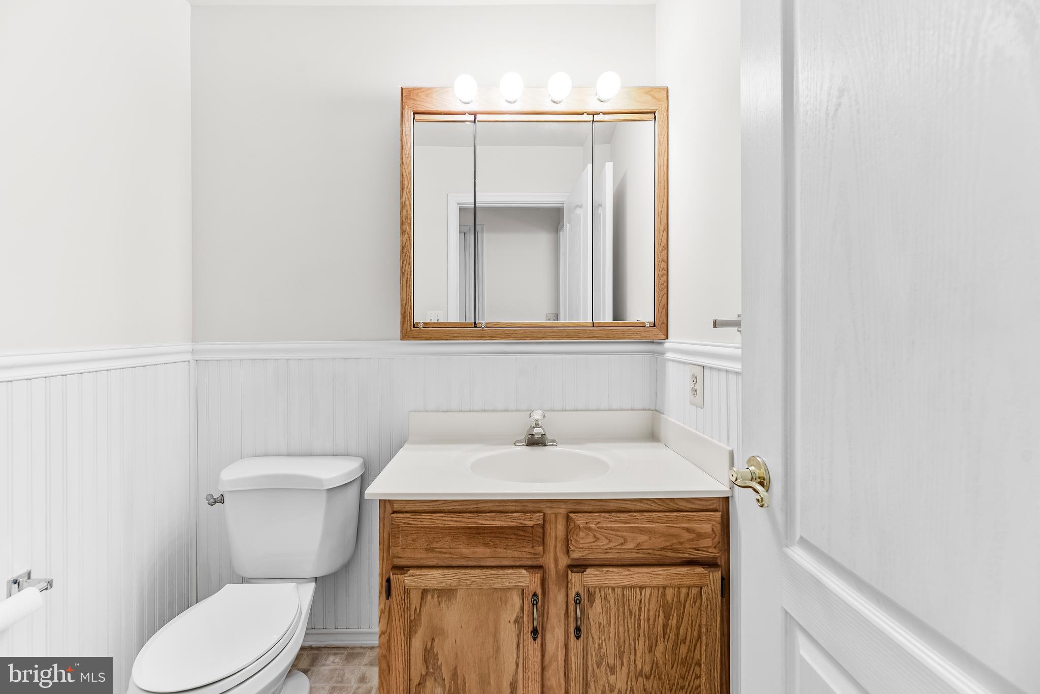 5965 Ketch Road Prince Frederick, MD 20678 - Photo 24 of 56 a bathroom with a toilet sink and mirror