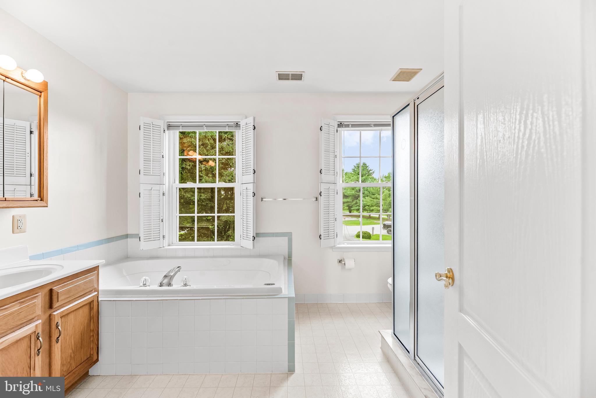 5965 Ketch Road Prince Frederick, MD 20678 - Photo 32 of 56 a bathroom with a bathtub and windows