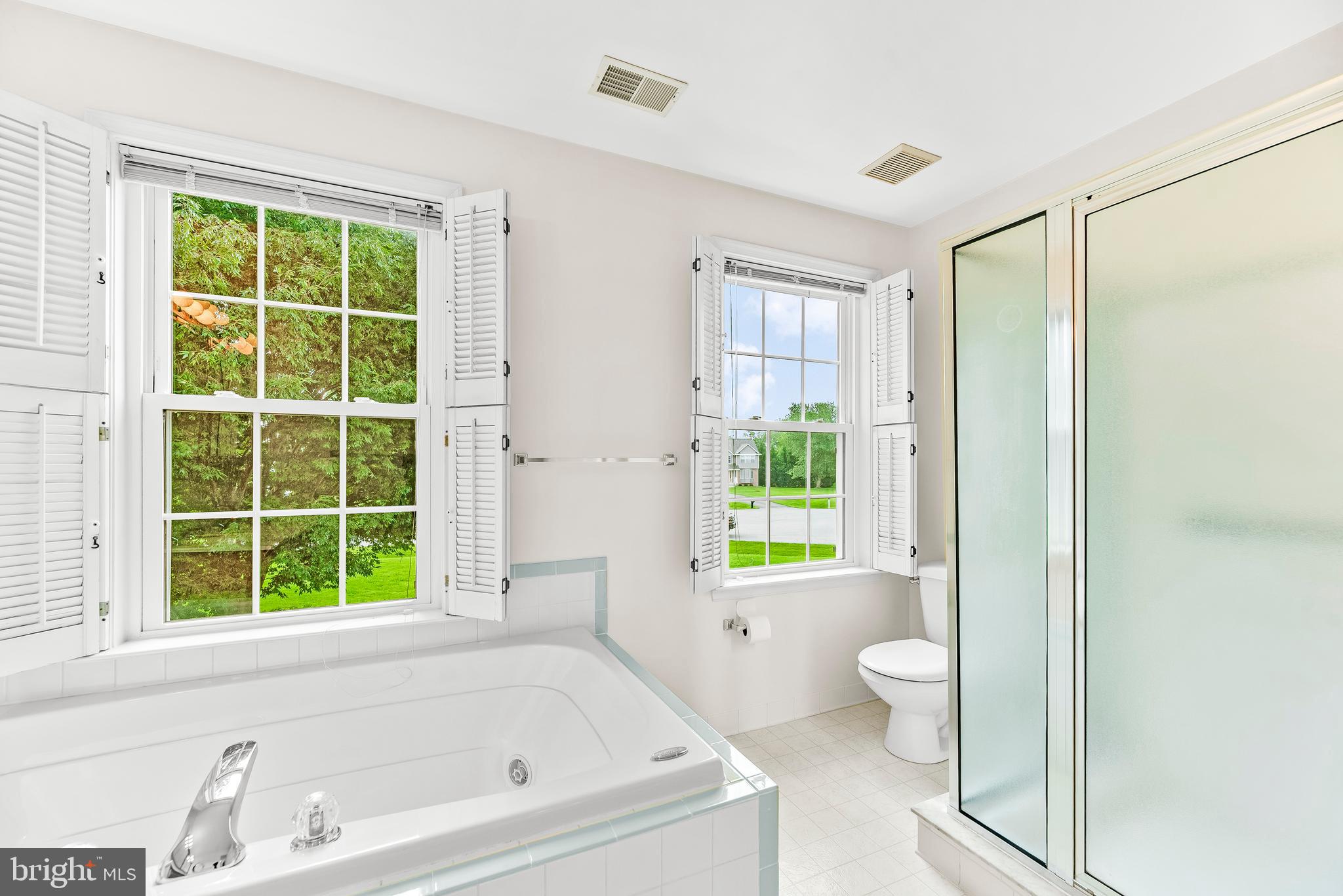 5965 Ketch Road Prince Frederick, MD 20678 - Photo 33 of 56 a bathroom with a bathtub toilet and window
