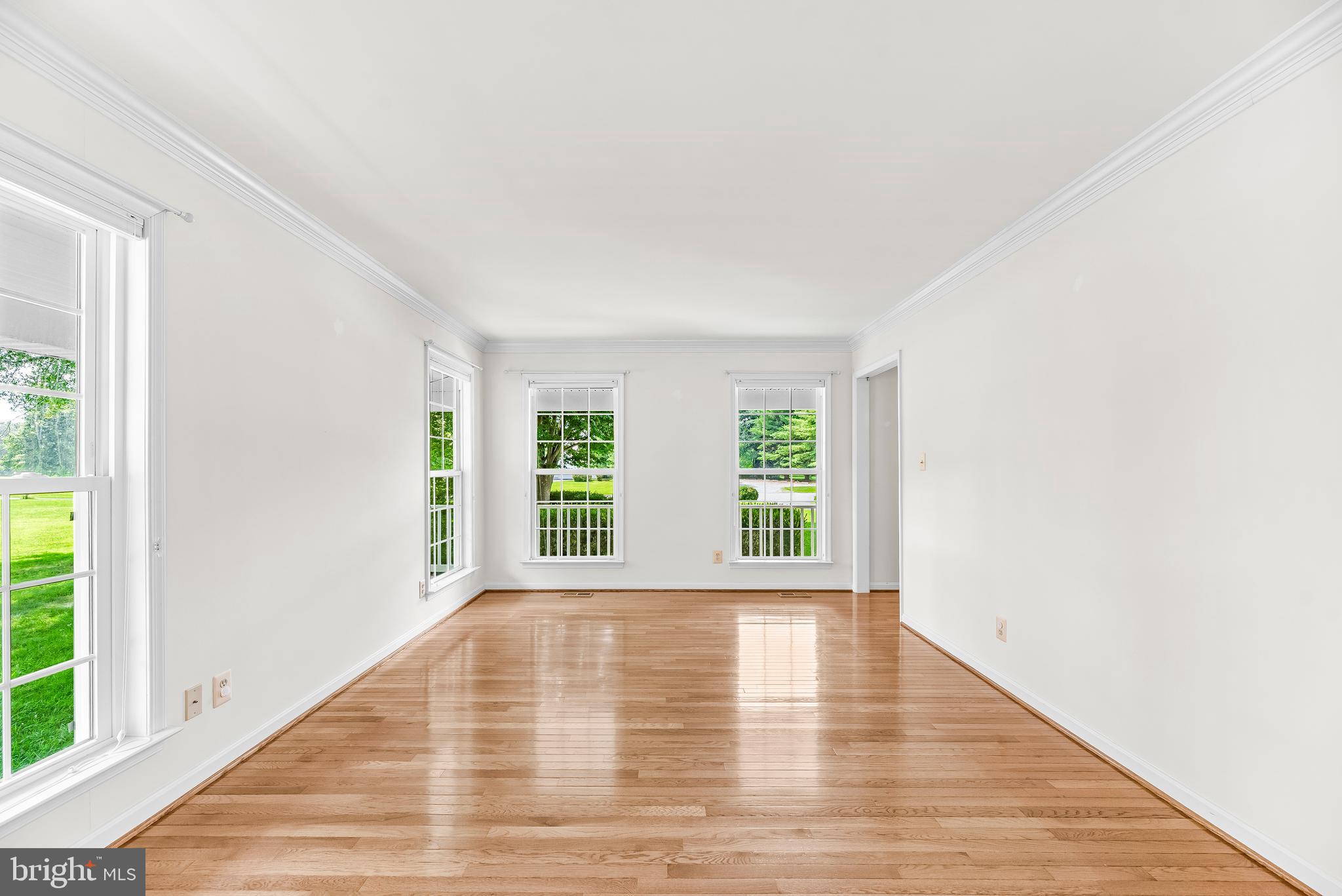 5965 Ketch Road Prince Frederick, MD 20678 - Photo 9 of 56 a view of an empty room with wooden floor and a window