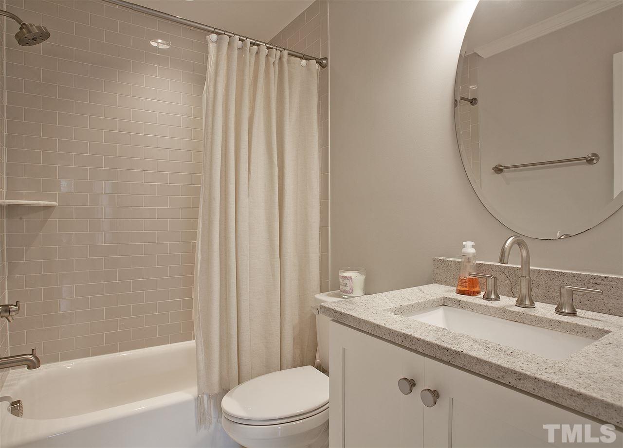 125 Plainview Avenue Raleigh, NC 27604 - Photo 20 of 27 a bathroom with a granite countertop sink a toilet and shower