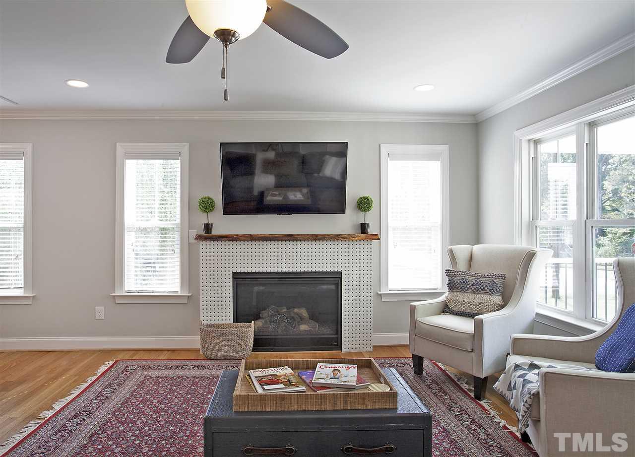 125 Plainview Avenue Raleigh, NC 27604 - Photo 5 of 27 a living room with furniture a flat screen tv and a fireplace