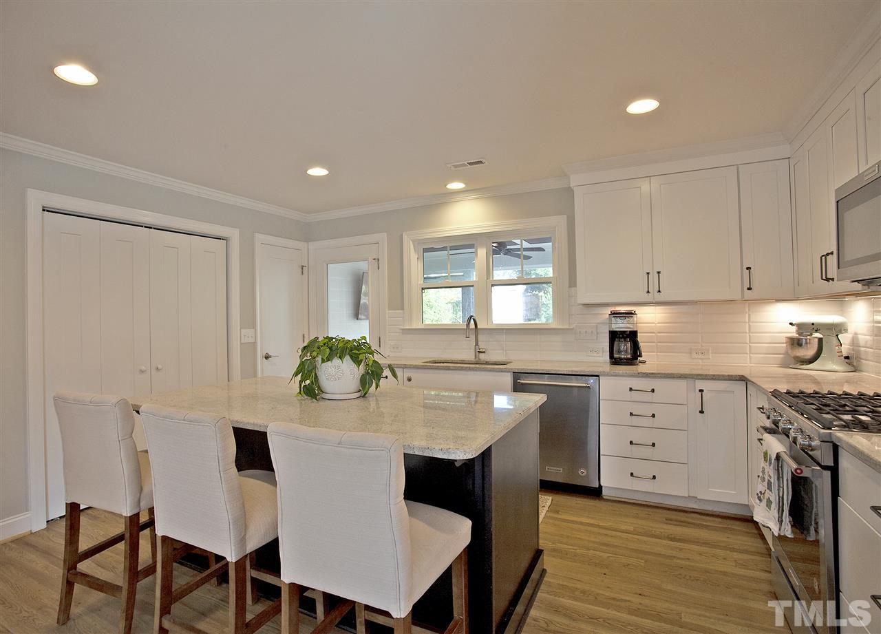 125 Plainview Avenue Raleigh, NC 27604 - Photo 9 of 27 a kitchen with stainless steel appliances granite countertop a table and chairs in it