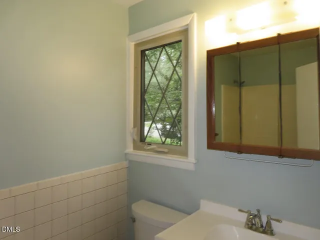 a bathroom with a window and a shower