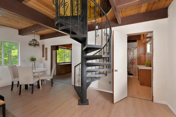 a view of entryway and hall with wooden floor
