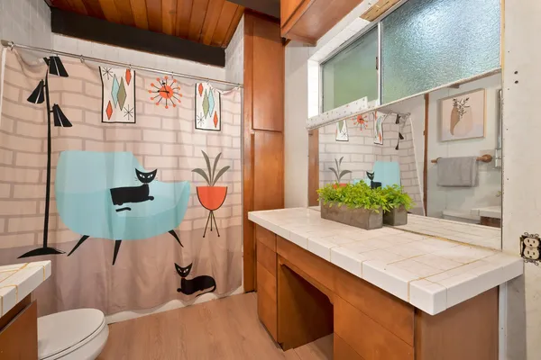 a bathroom with a sink a toilet and shower