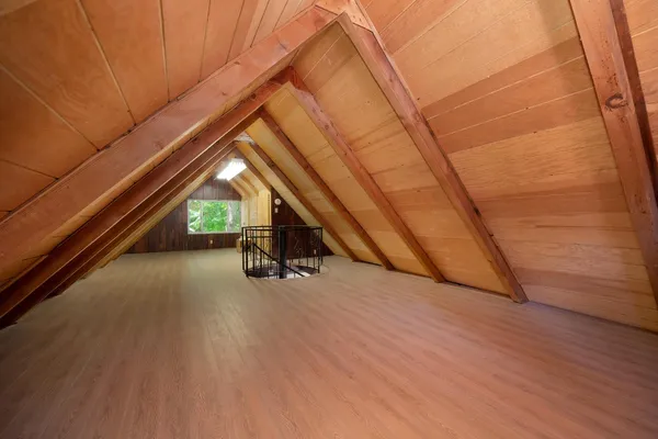 a view of an empty room with wooden stairs