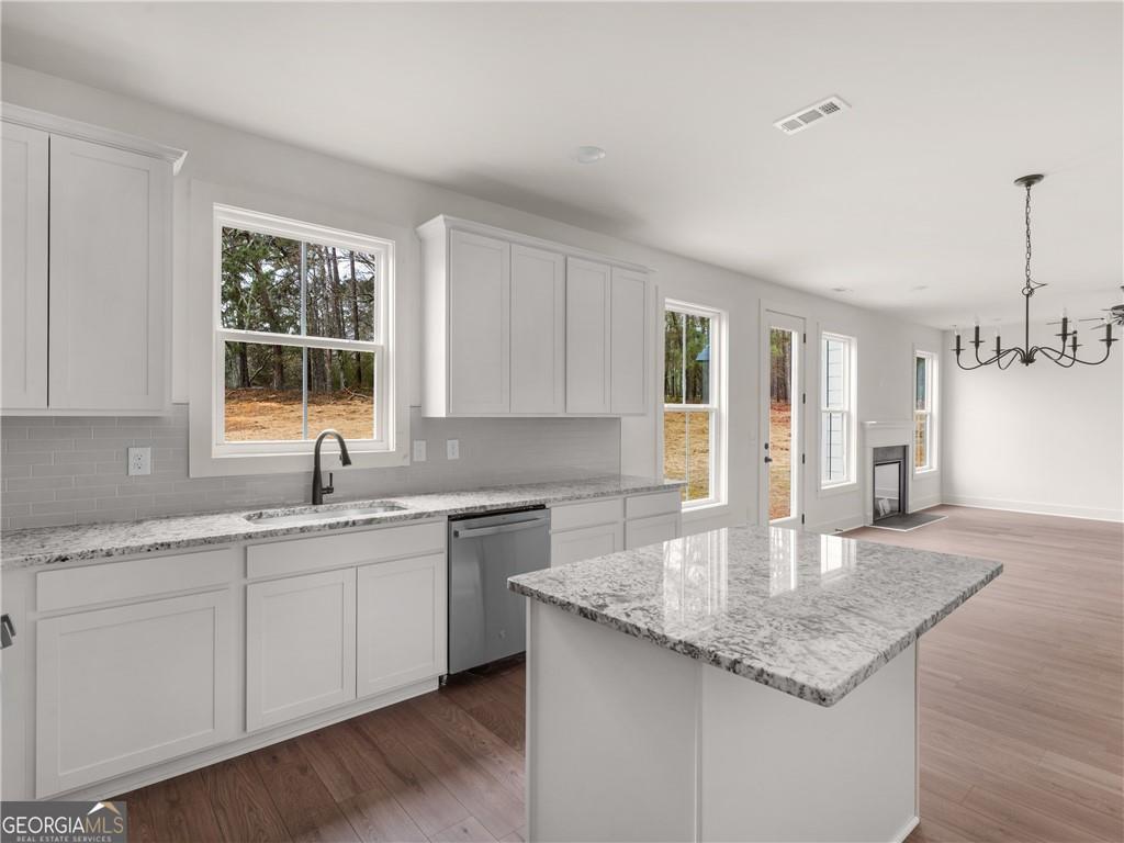 172 Loyd Road Mansfield, GA 30055 - Photo 2 of 17 a kitchen with a sink cabinets and window