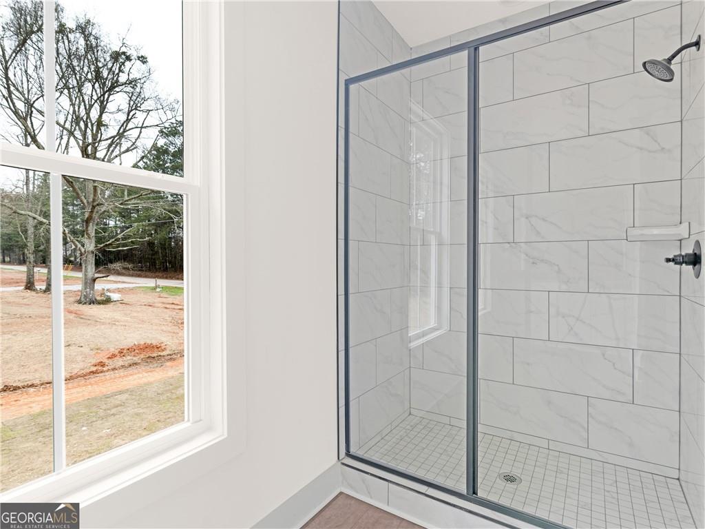 172 Loyd Road Mansfield, GA 30055 - Photo 8 of 17 a bathroom with a glass shower door