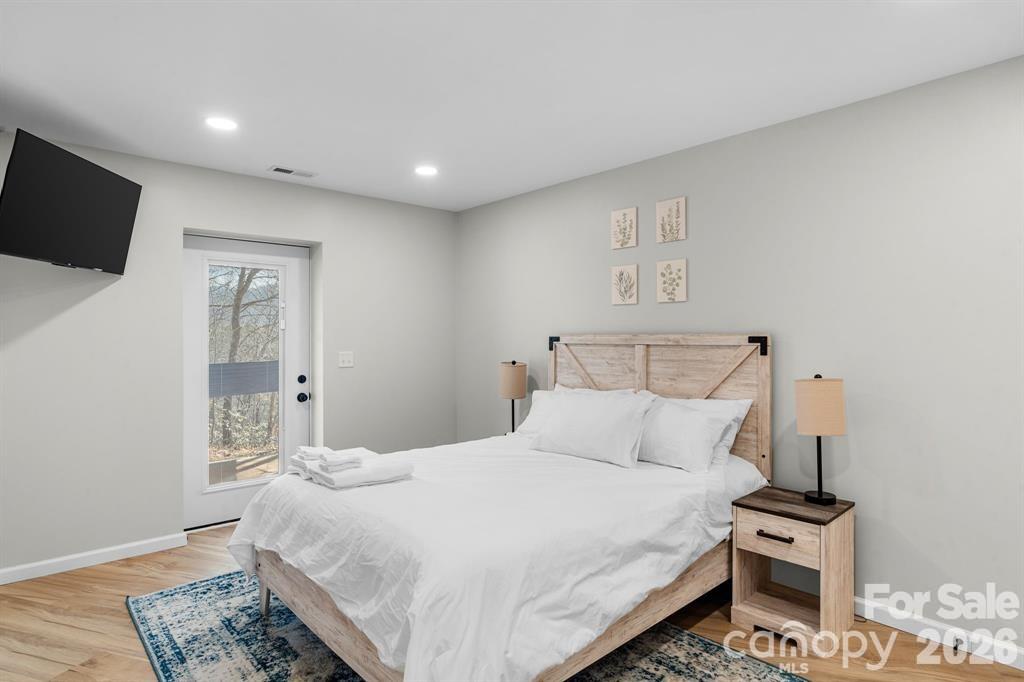 56 Great Horned Owl Road Candler, NC 28715 - Photo 23 of 32 a bedroom with a bed and flat screen tv