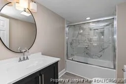 a bathroom with a sink a mirror and a glass door shower