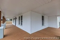 a view of a big room with wooden floor and a living room