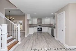 a kitchen with wooden floors and refrigerator