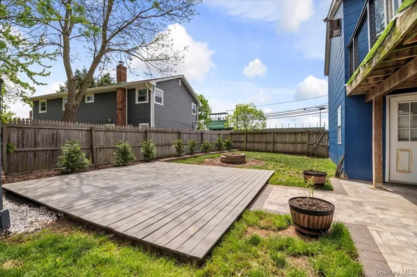 a view of a backyard with furniture and a fire pit