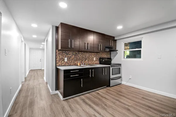 a kitchen with granite countertop a stove and cabinets