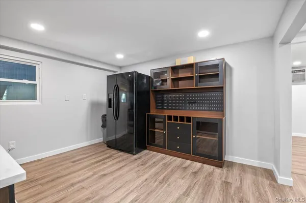 a room with a dresser and a window