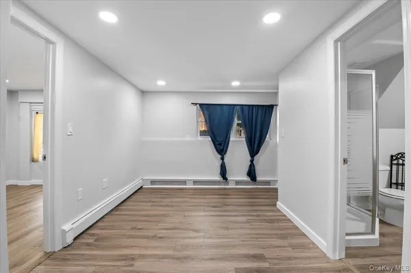 a view of empty room with wooden floor
