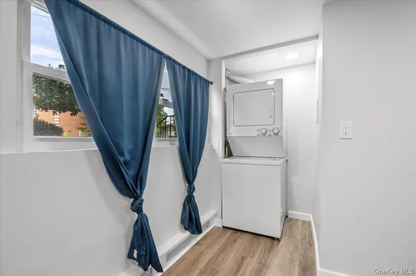 a storage room with wooden floor washer and dryer