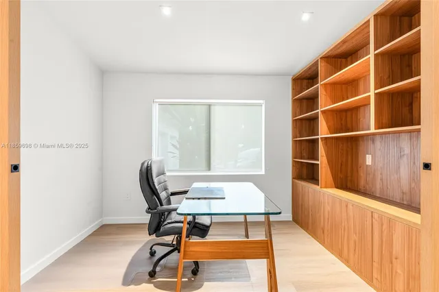 a view of a room with wooden floor and windows