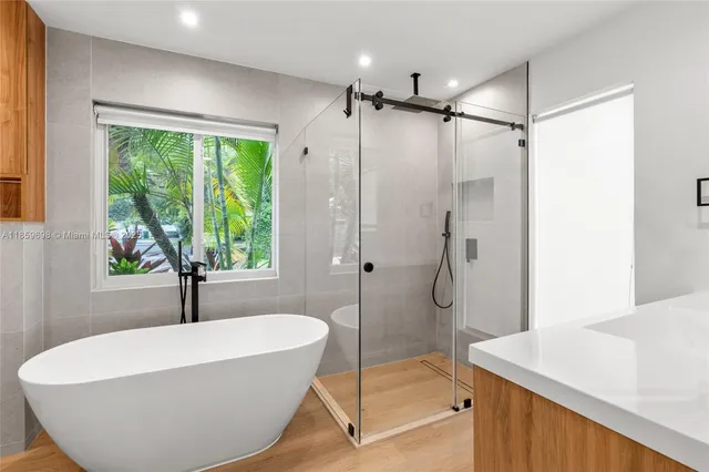 a bathroom with a bathtub and a shower