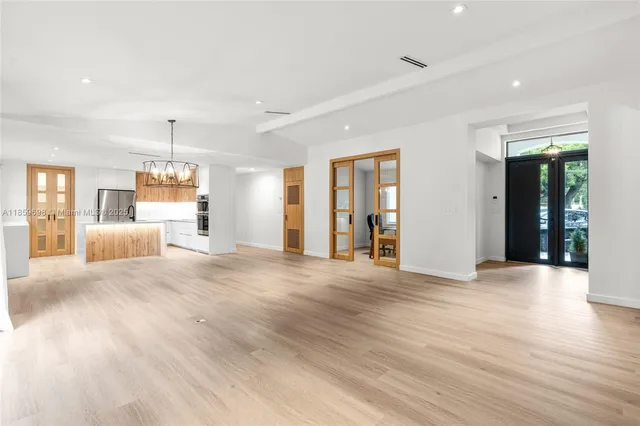 a view of a livingroom with wooden floor and furniture