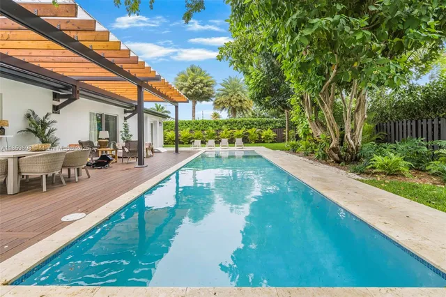 a view of a swimming pool with an outdoor seating