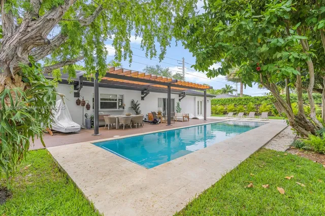 a view of a backyard with a small deck and wooden floor