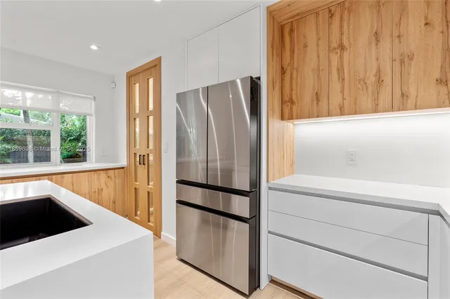 a view of a kitchen with a tub and utility room