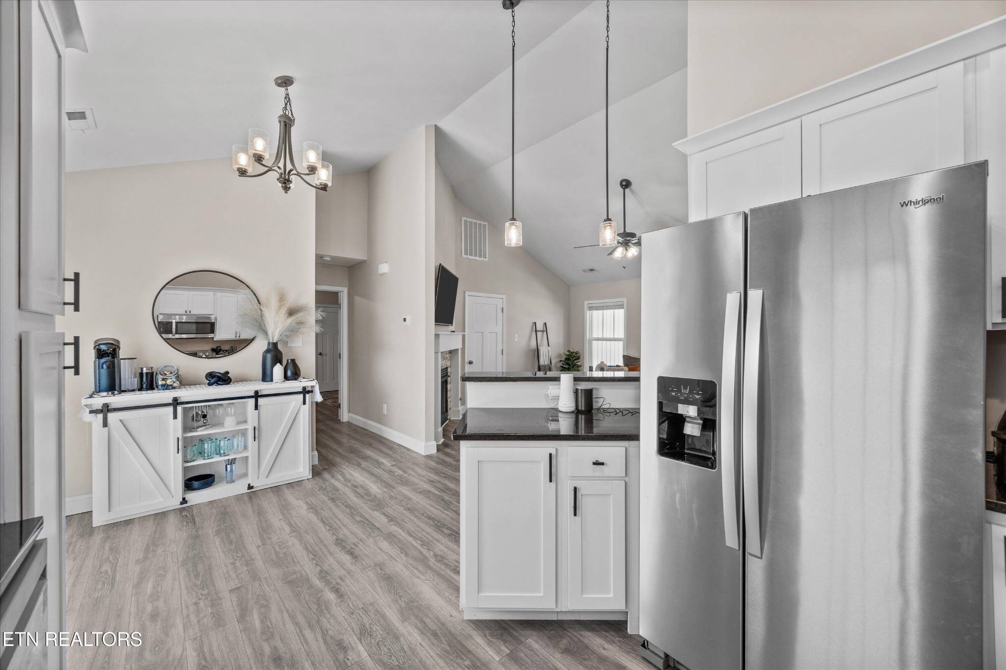 207 Daniel Morris Point Clinton, TN 37716 - Photo 11 of 42 a kitchen with stainless steel appliances a stove a refrigerator and white cabinets with wooden floor