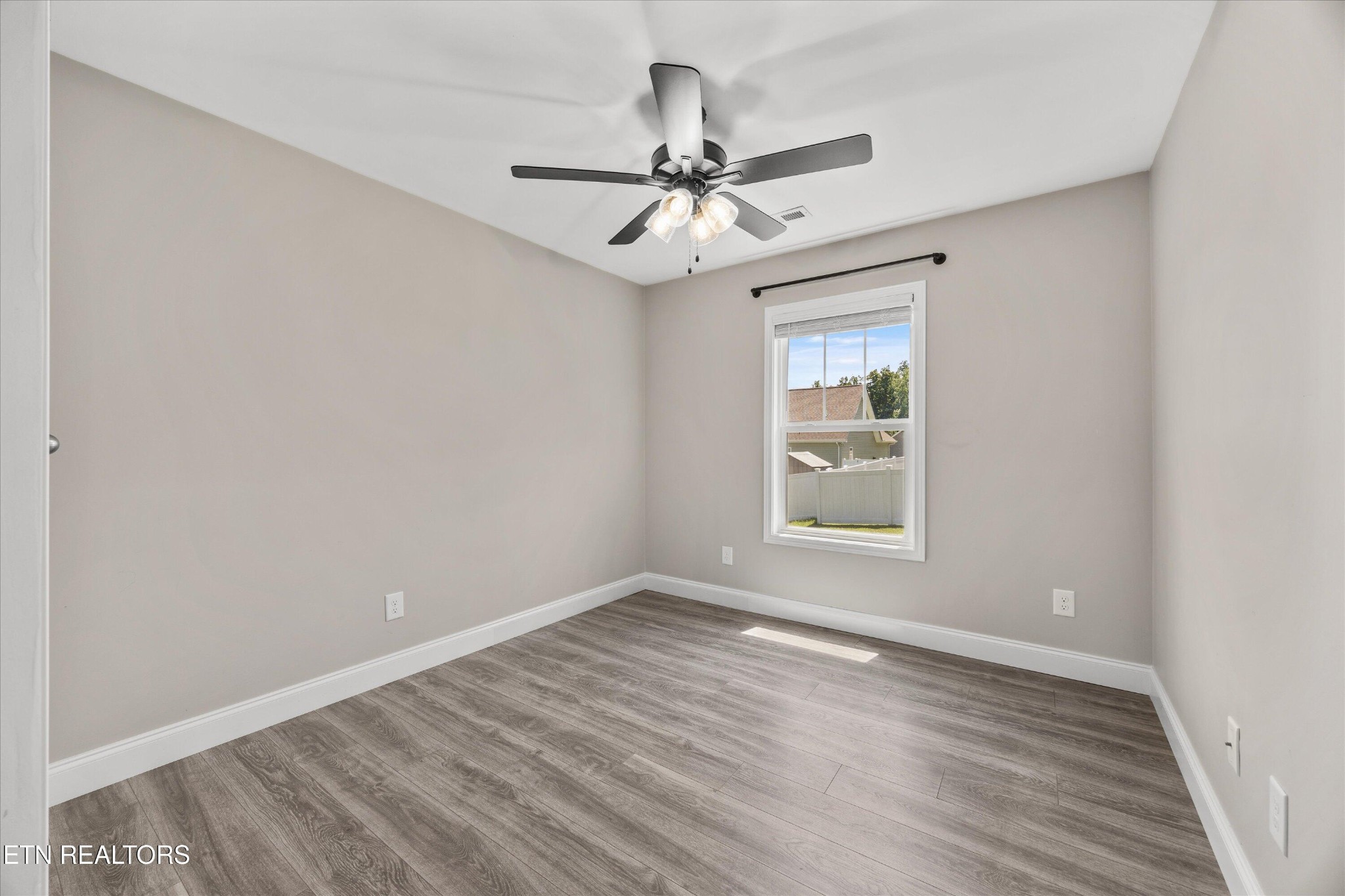 207 Daniel Morris Point Clinton, TN 37716 - Photo 17 of 42 a view of an empty room with wooden floor and a window