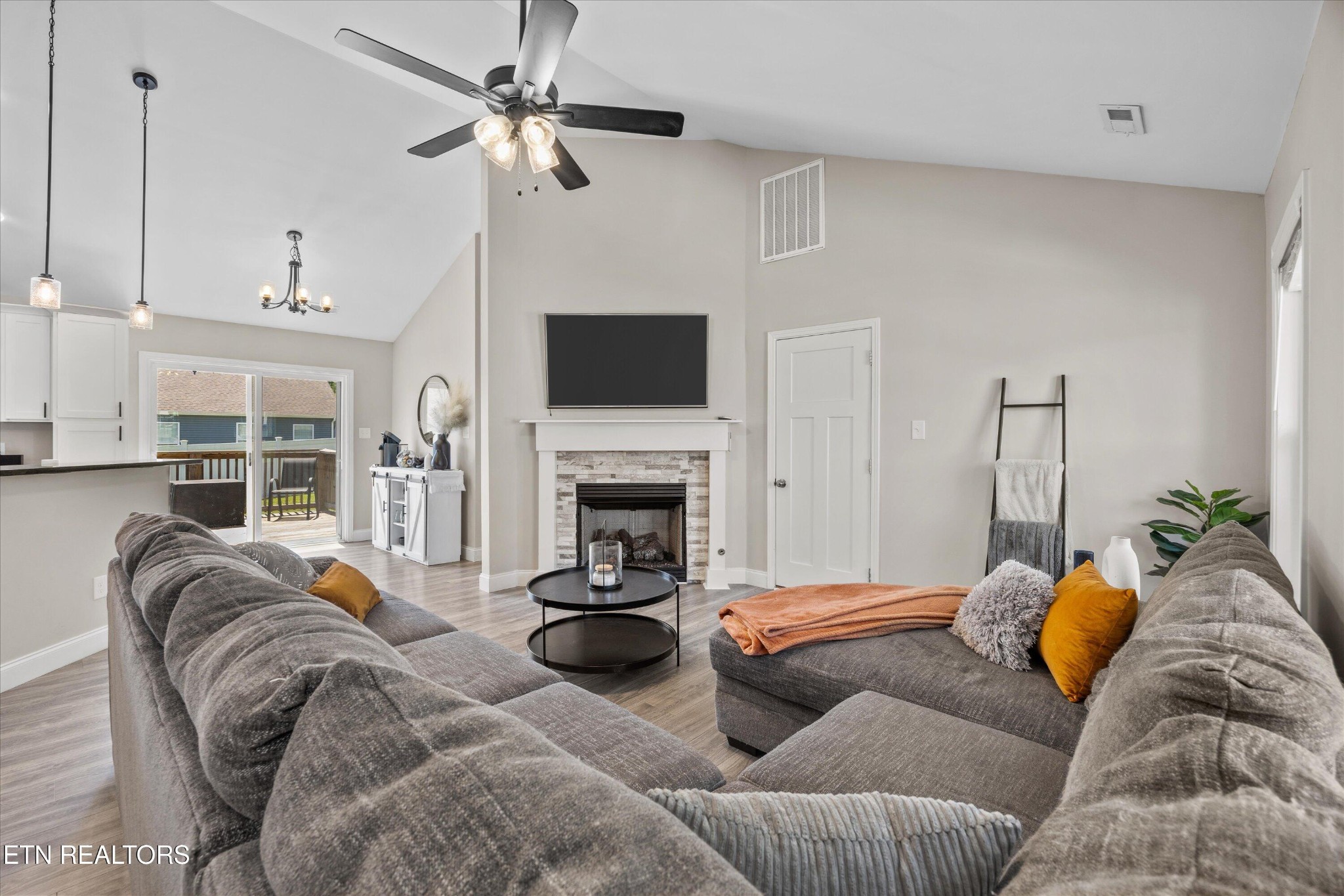 207 Daniel Morris Point Clinton, TN 37716 - Photo 3 of 42 a living room with furniture a fireplace and a flat screen tv