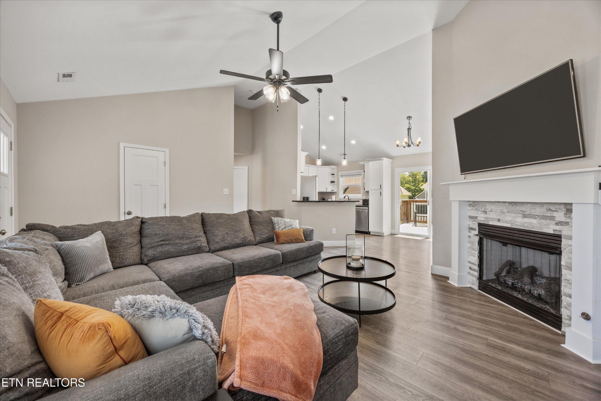 207 Daniel Morris Point Clinton, TN 37716 - Photo 5 of 42 a living room with furniture a fireplace and a flat screen tv