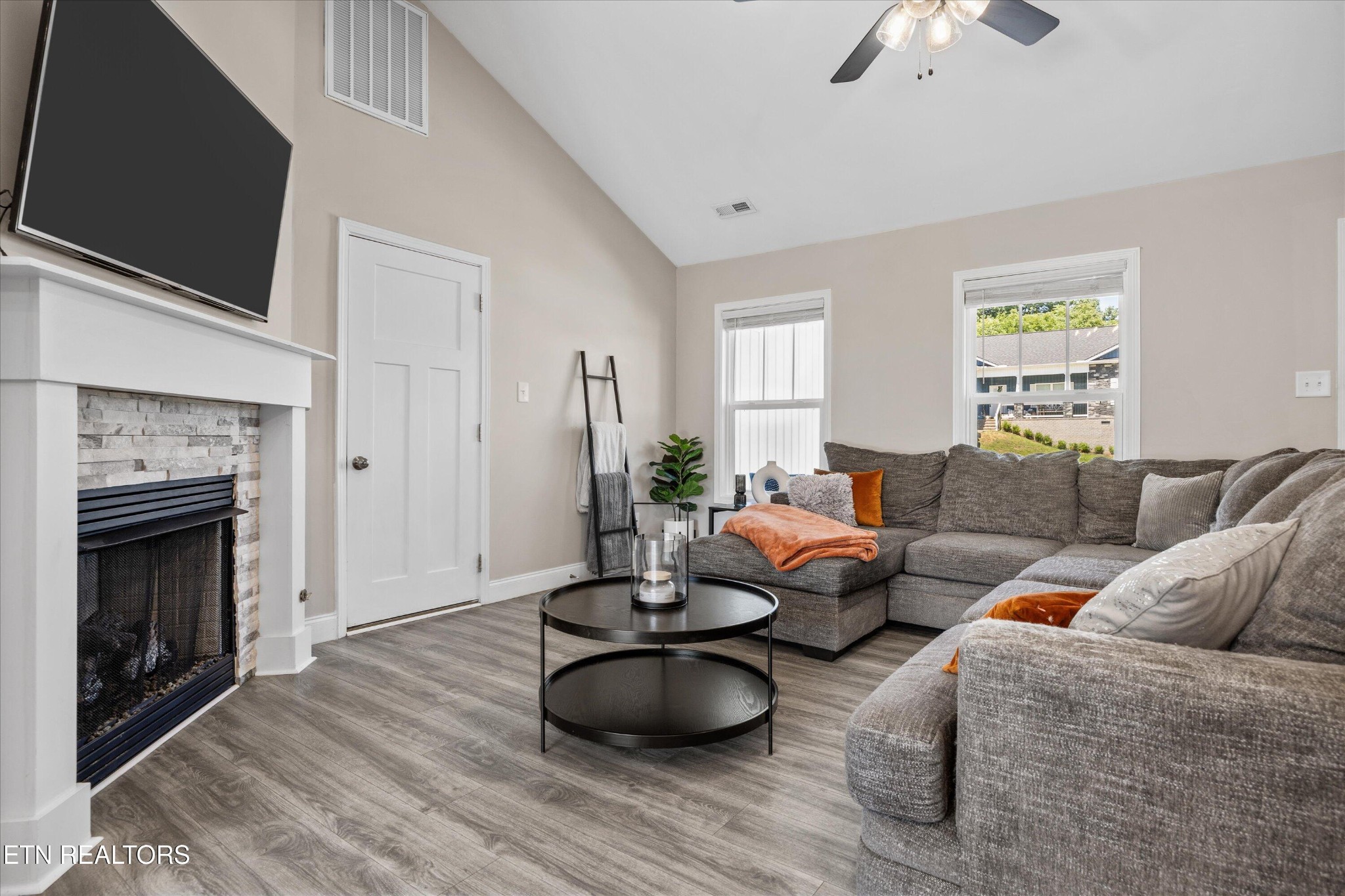 207 Daniel Morris Point Clinton, TN 37716 - Photo 6 of 42 a living room with furniture a fireplace and a flat screen tv