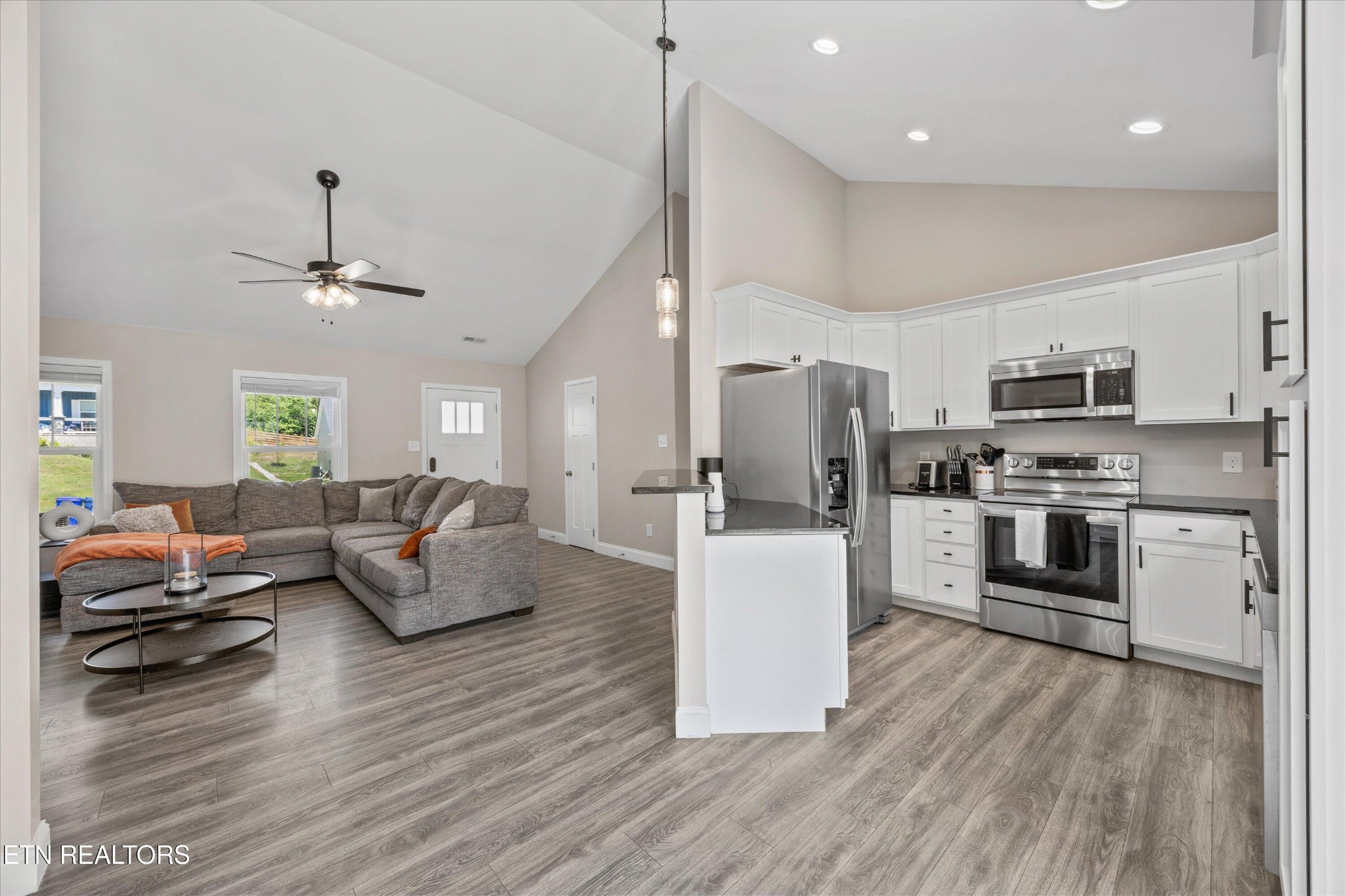 207 Daniel Morris Point Clinton, TN 37716 - Photo 8 of 42 a living room with stainless steel appliances furniture a chandelier and a view of kitchen