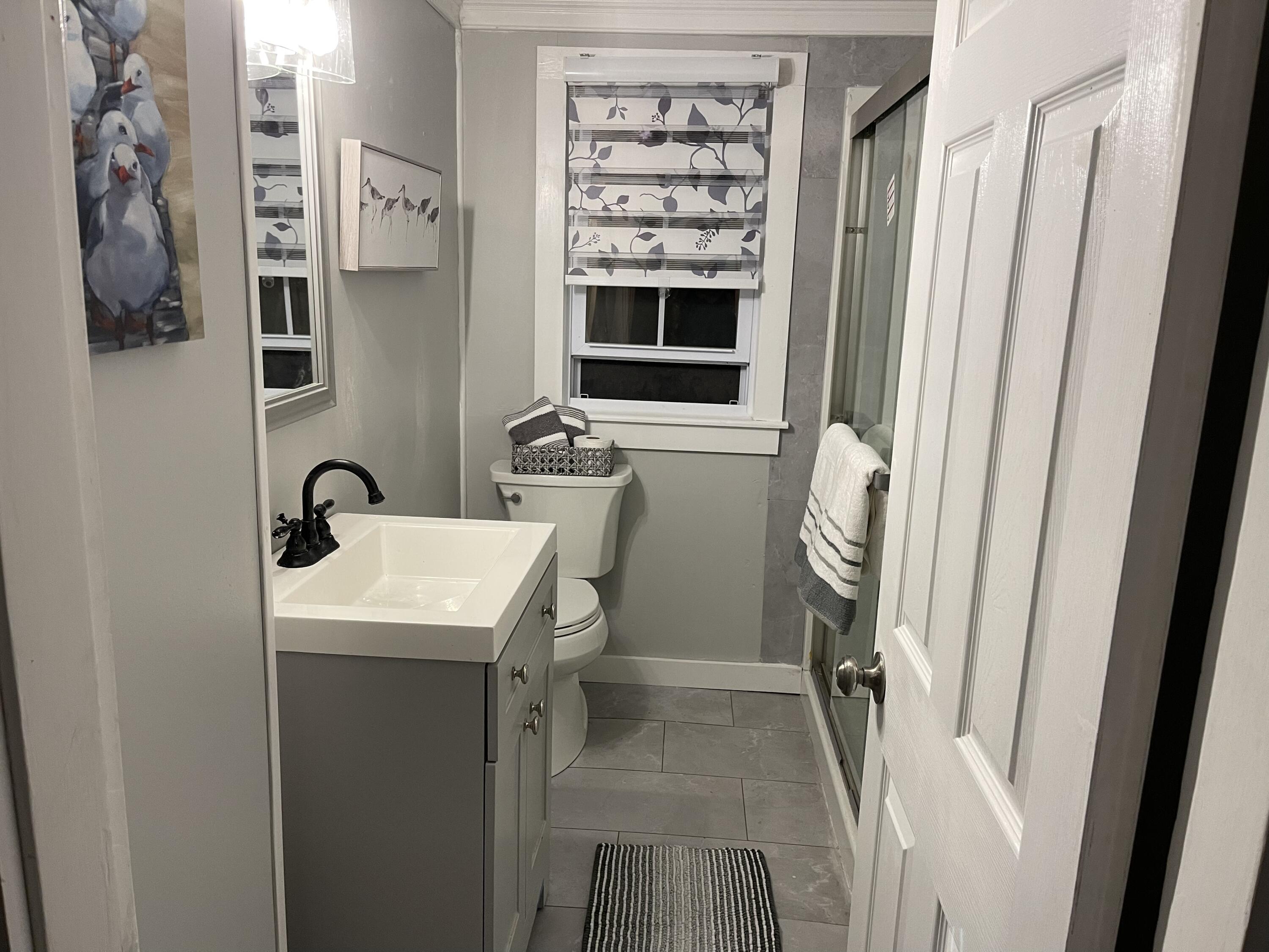 25 Walker Road Eastham, MA 02642 - Photo 11 of 17 a bathroom with a sink a toilet and a mirror