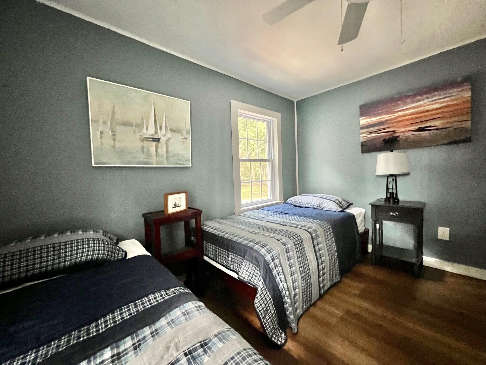25 Walker Road Eastham, MA 02642 - Photo 17 of 17 a bedroom with a bed and dresser with wooden floor