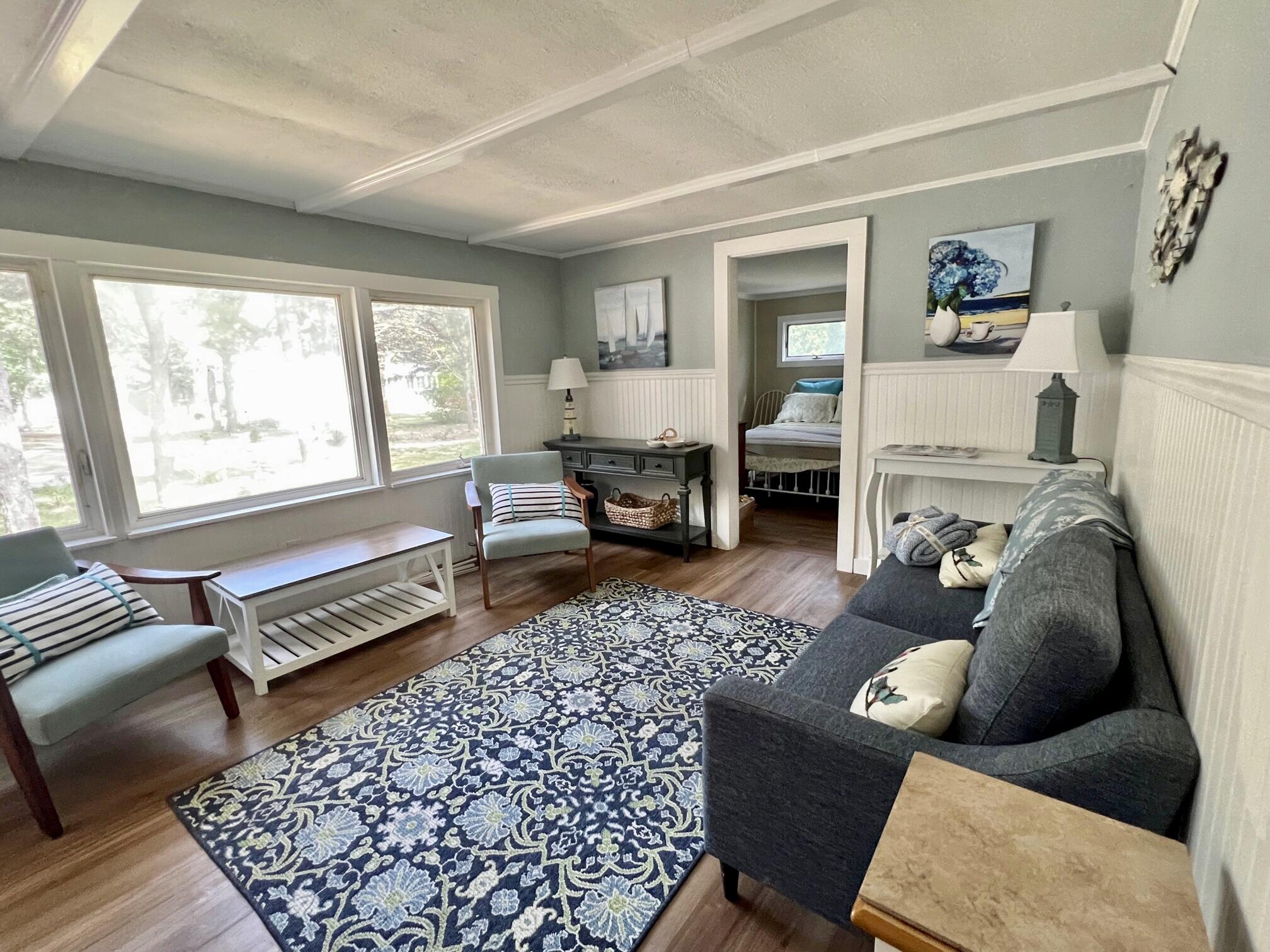 25 Walker Road Eastham, MA 02642 - Photo 3 of 17 a living room with furniture and a fireplace