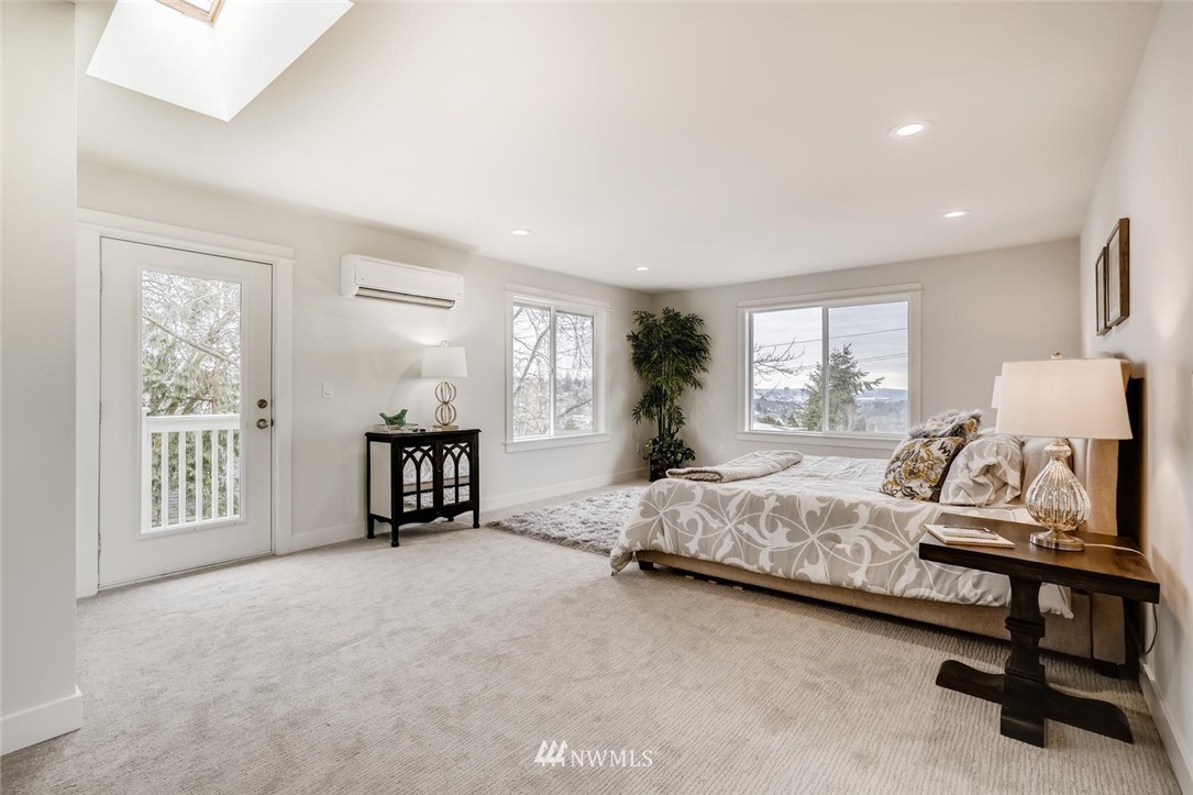 1533 33rd Avenue Seattle, WA 98122 - Photo 15 of 28 a spacious bedroom with a bed a table and large window