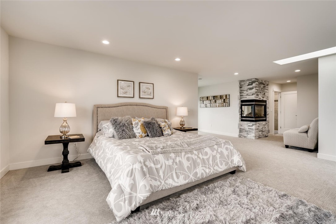 1533 33rd Avenue Seattle, WA 98122 - Photo 16 of 28 a spacious bedroom with a bed and a couch