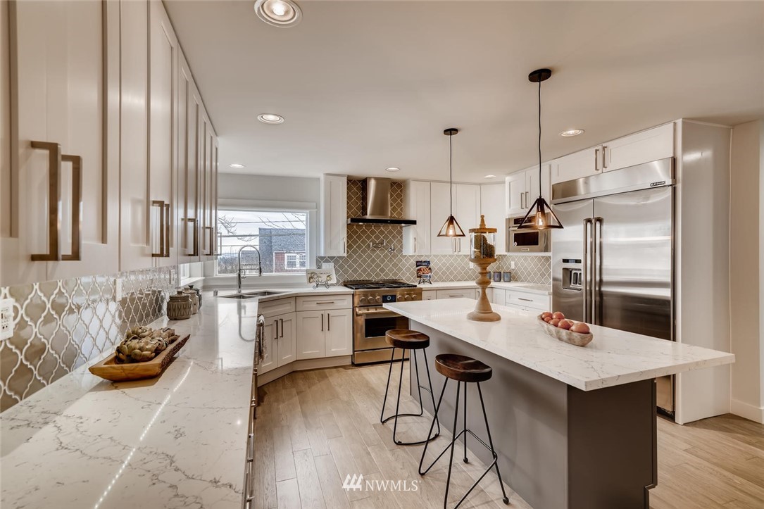 1533 33rd Avenue Seattle, WA 98122 - Photo 8 of 28 a kitchen with a sink stove and refrigerator
