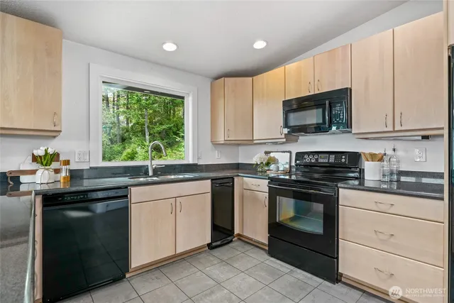 a kitchen with granite countertop white cabinets and appliances